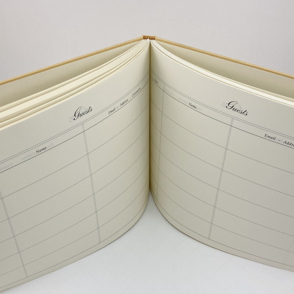 Open notebook with guest list pages on a white background