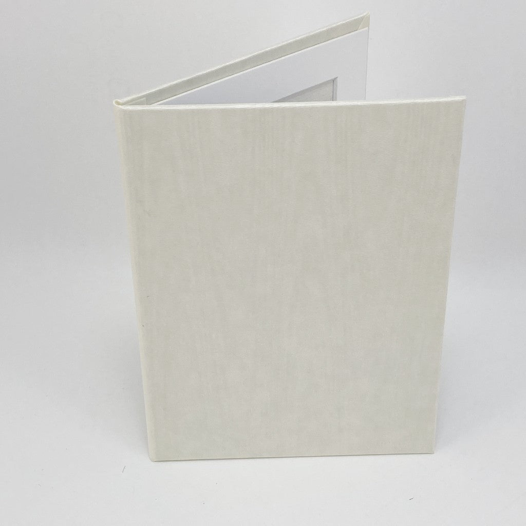 White silk fabric-covered photo frame on a white background