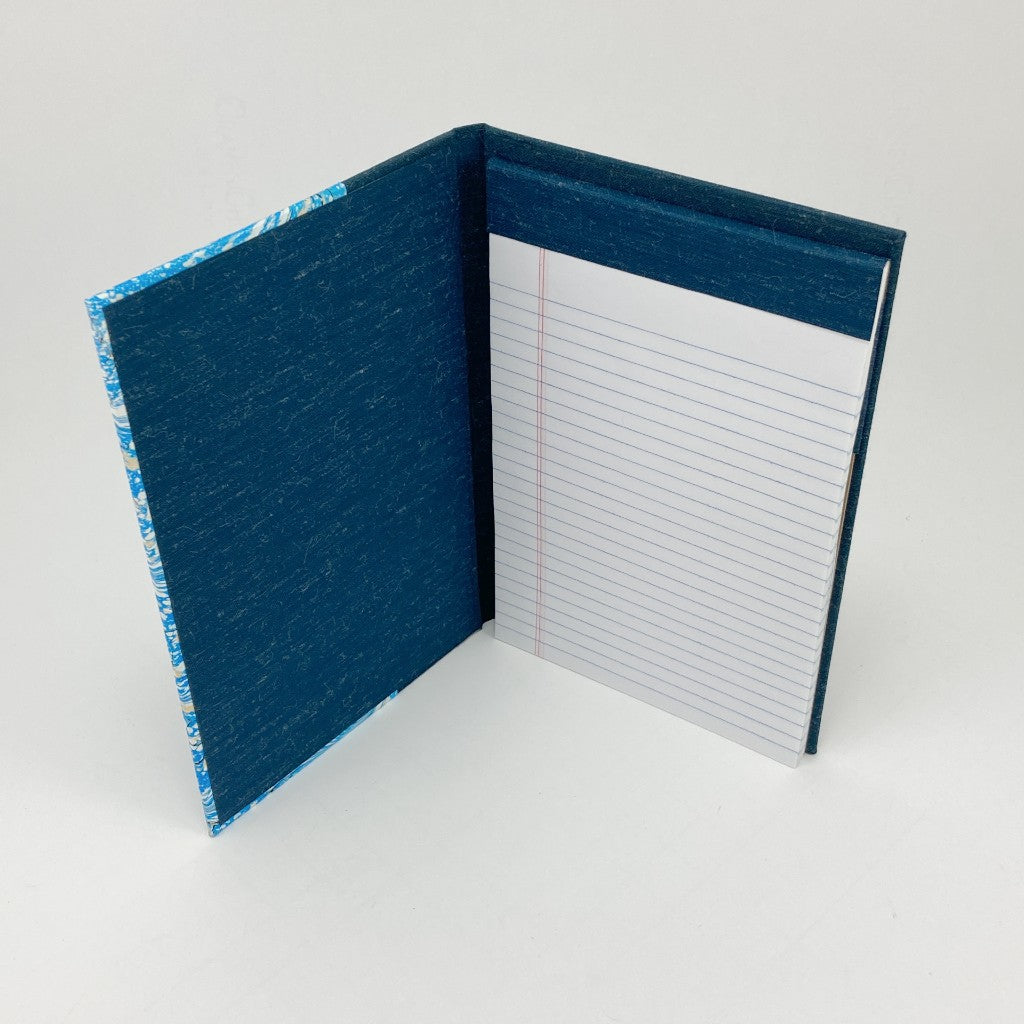 Open blue notebook with lined pages on a white background