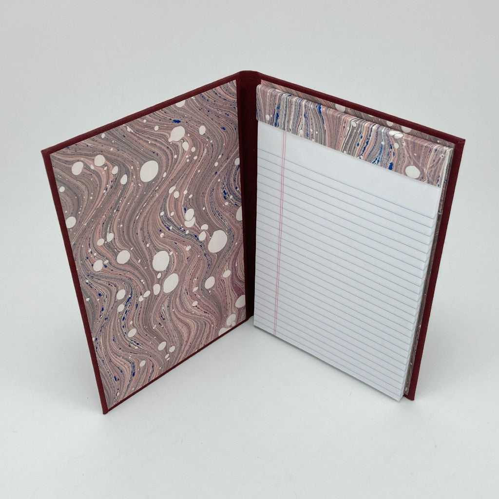 Notebook with marbled cover and lined pages on a white background